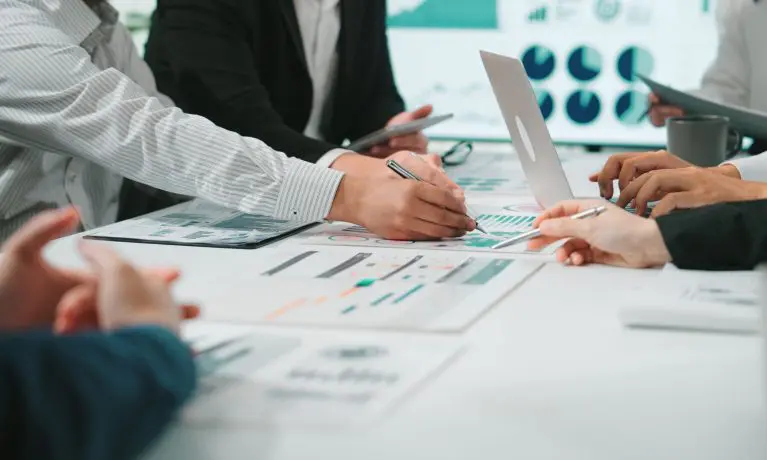 people discussing papers at a table