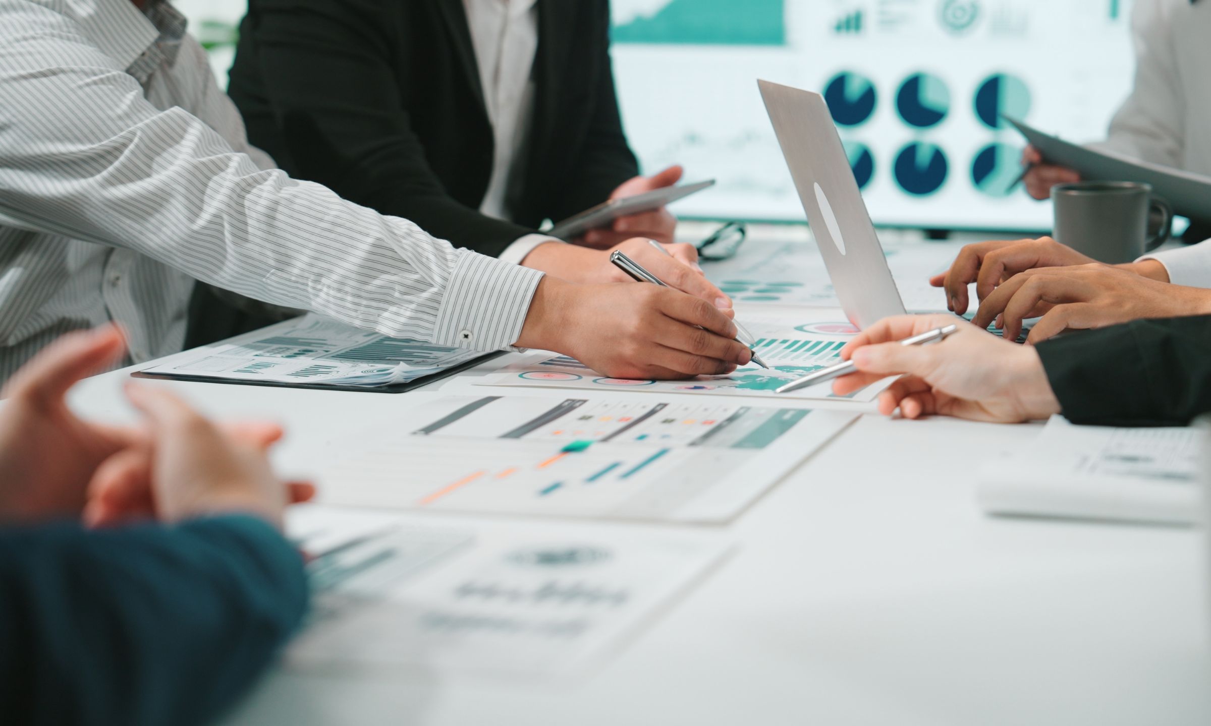 people discussing papers at a table