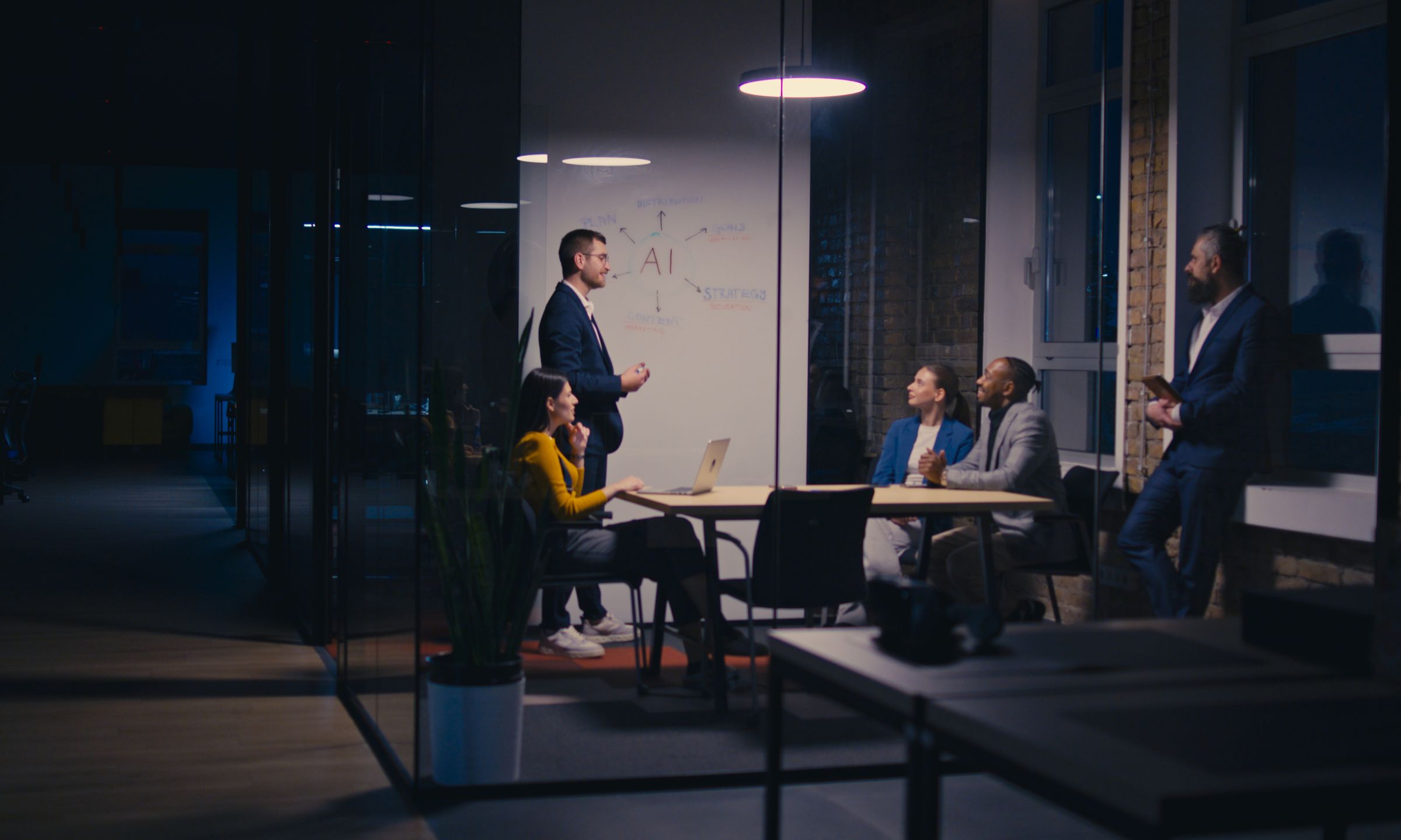 A group of people brainstorming ideas about AI on a whiteboard in an office setting