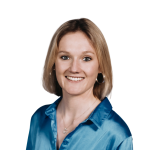 Professional headshot of a woman in a blue blouse smiling at the camera.