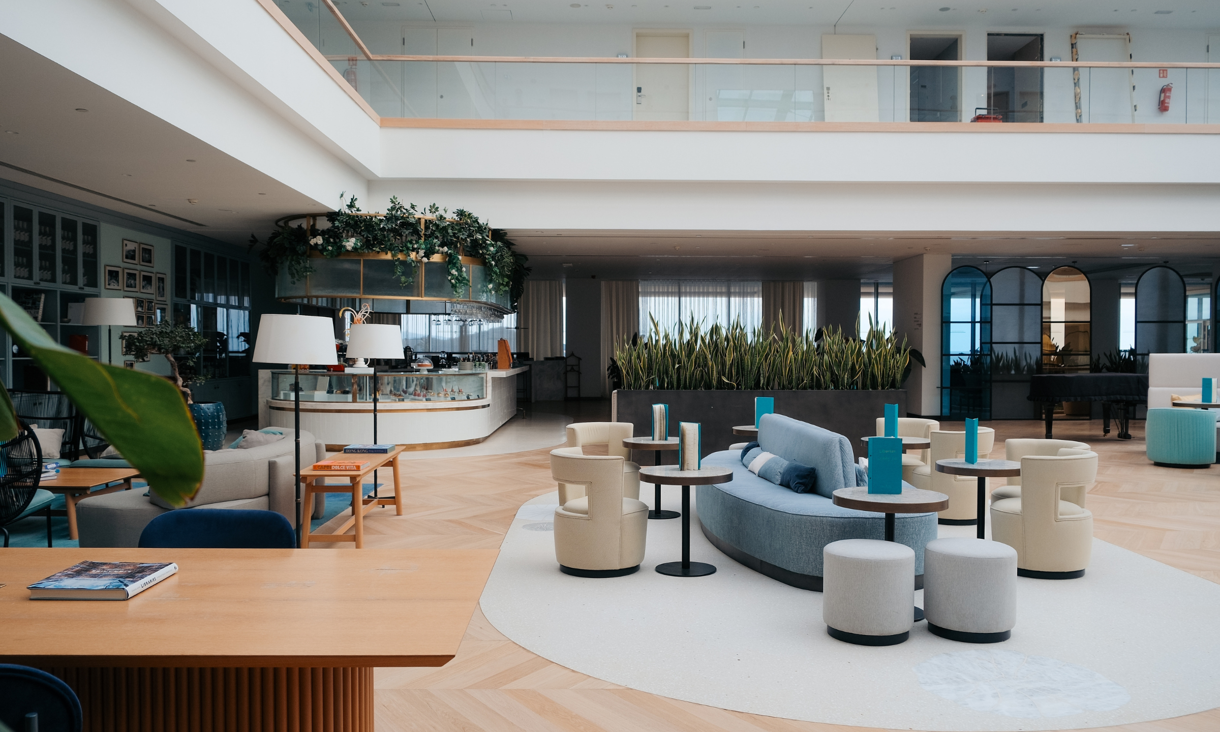 Contemporary hotel lobby with modern lounge seating and indoor greenery.